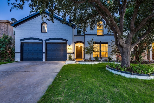 view of front facade with a garage and a lawn