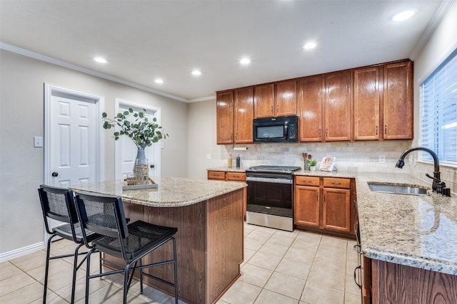 kitchen with stainless steel electric range, sink, backsplash, a kitchen island, and crown molding