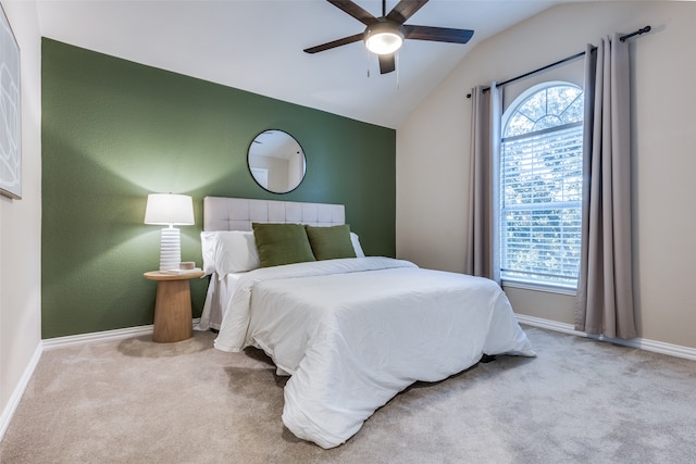 carpeted bedroom with vaulted ceiling and ceiling fan