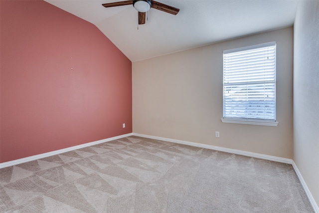 carpeted empty room with ceiling fan and vaulted ceiling