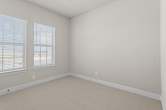 unfurnished room featuring light colored carpet