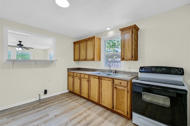 kitchen with light hardwood / wood-style floors, sink, ceiling fan, and white electric range