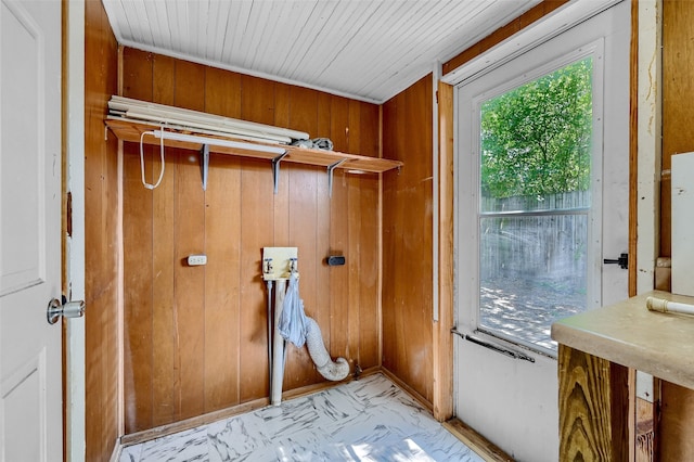 laundry area featuring wooden walls