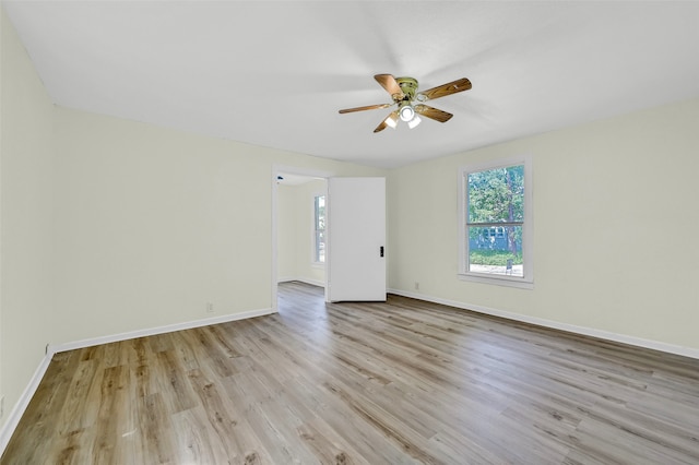 empty room featuring light wood-type flooring and ceiling fan