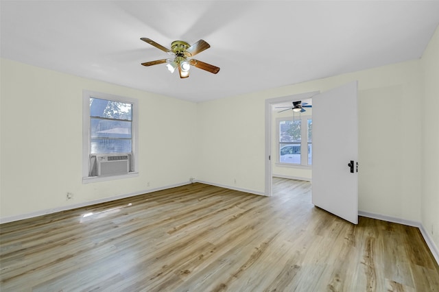 spare room with a healthy amount of sunlight, ceiling fan, and light hardwood / wood-style flooring