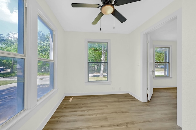 spare room with light hardwood / wood-style flooring and ceiling fan