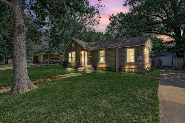 view of front of house with a lawn and an outdoor structure