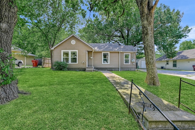 ranch-style home featuring a garage and a front lawn