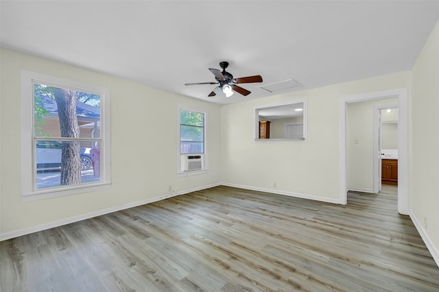 spare room with a healthy amount of sunlight, light hardwood / wood-style flooring, and cooling unit