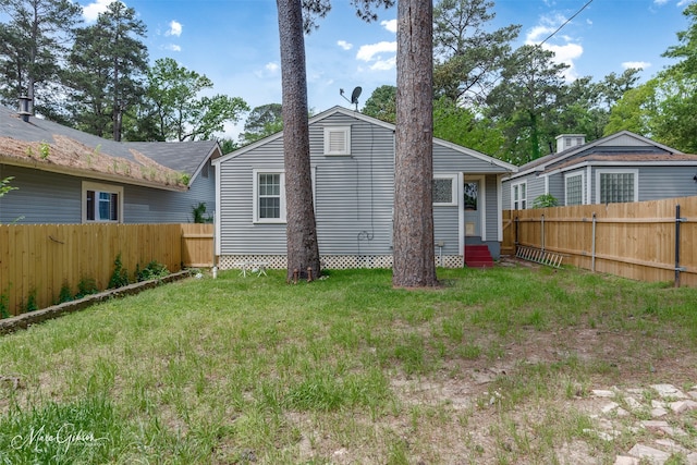 rear view of house with a lawn