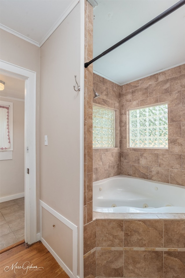 3827 Baltimore Ave, Shreveport, LA 71106 - bathroom featuring a jetted tub, ornamental molding, tiled shower, and wood finished floors