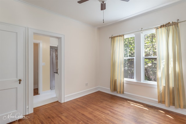 empty room with ornamental molding, ceiling fan, and hardwood / wood-style floors