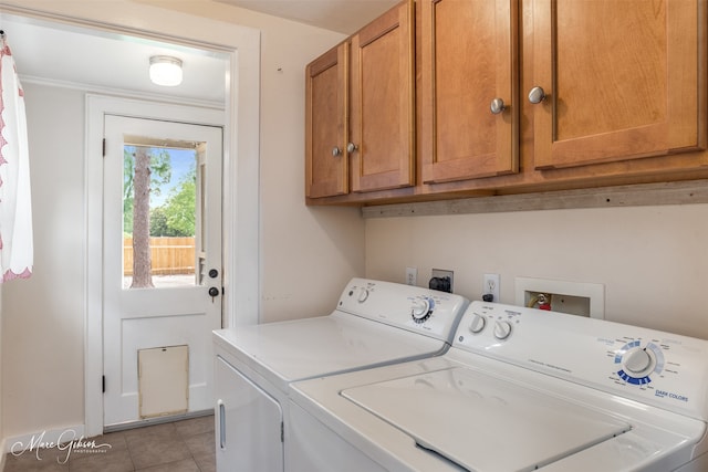 washroom featuring cabinets, light tile patterned floors, and independent washer and dryer