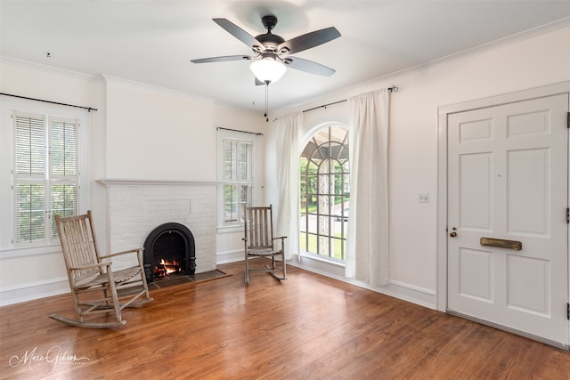 sitting room with ornamental molding, a healthy amount of sunlight, hardwood / wood-style flooring, and ceiling fan