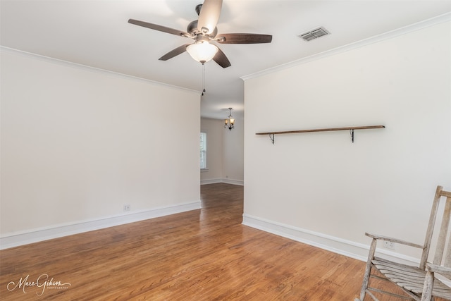 empty room featuring ornamental molding, ceiling fan, and hardwood / wood-style floors