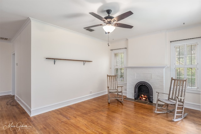 unfurnished living room with ceiling fan, hardwood / wood-style floors, and crown molding