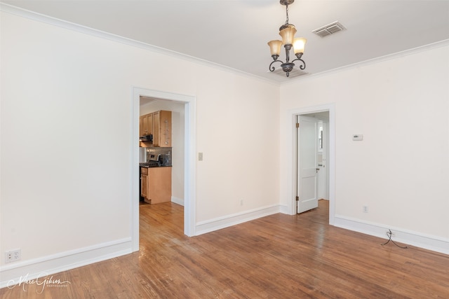 3827 Baltimore Ave, Shreveport, LA 71106 - empty room with visible vents, ornamental molding, baseboards, and a chandelier