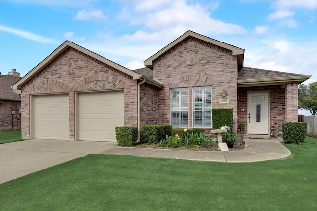 view of front of home featuring a garage and a front lawn