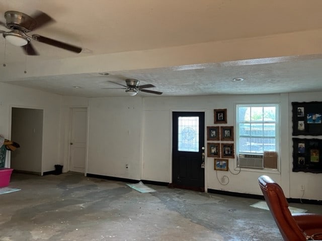 entrance foyer with concrete floors, a textured ceiling, and ceiling fan