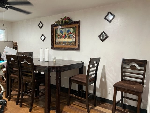 dining space with wood-type flooring and ceiling fan