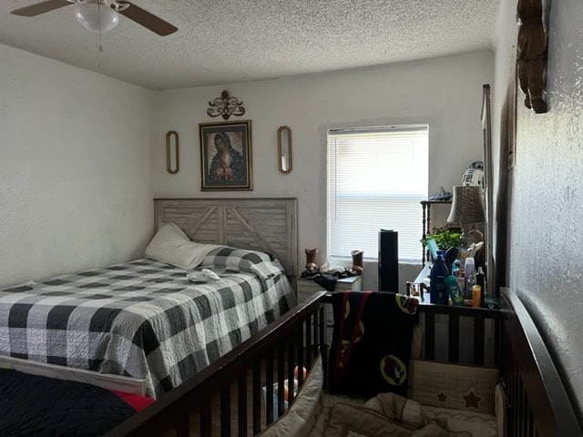 bedroom with a textured ceiling and ceiling fan