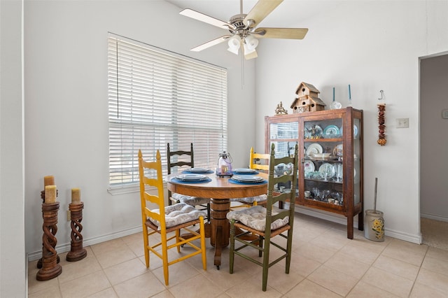dining space with ceiling fan and light tile patterned flooring
