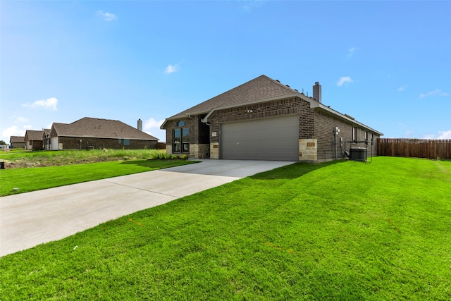 view of side of home featuring a garage and a yard