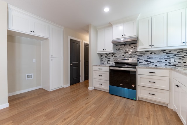 kitchen with white cabinets, light stone counters, light wood-type flooring, and stainless steel electric range oven