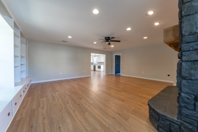 unfurnished living room featuring ceiling fan and light hardwood / wood-style flooring