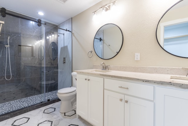 bathroom with toilet, a shower with shower door, and vanity