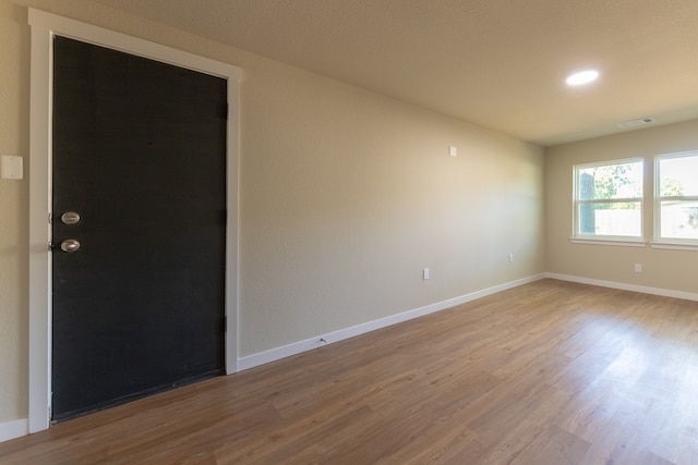 unfurnished room featuring hardwood / wood-style flooring