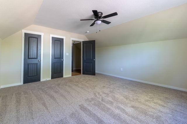 additional living space featuring carpet floors, ceiling fan, a textured ceiling, and vaulted ceiling