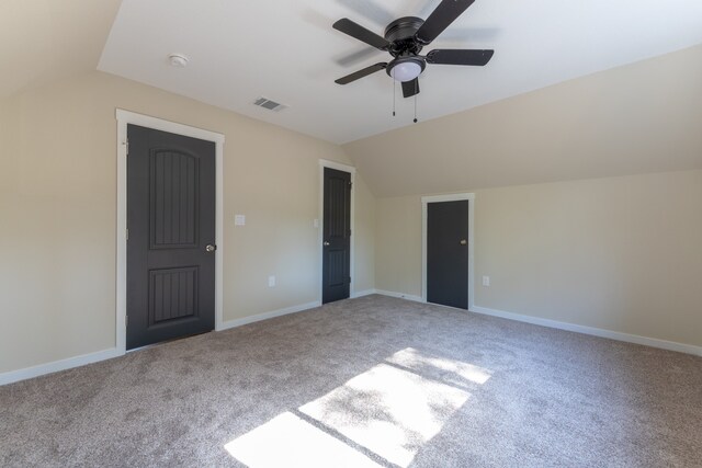 unfurnished bedroom with lofted ceiling, light colored carpet, and ceiling fan