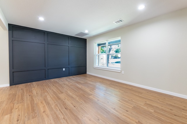 spare room featuring light hardwood / wood-style floors