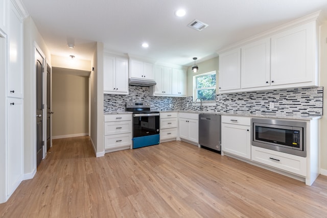 kitchen featuring appliances with stainless steel finishes, white cabinets, and light wood-type flooring