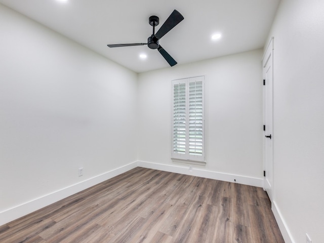 unfurnished room with ceiling fan and wood-type flooring