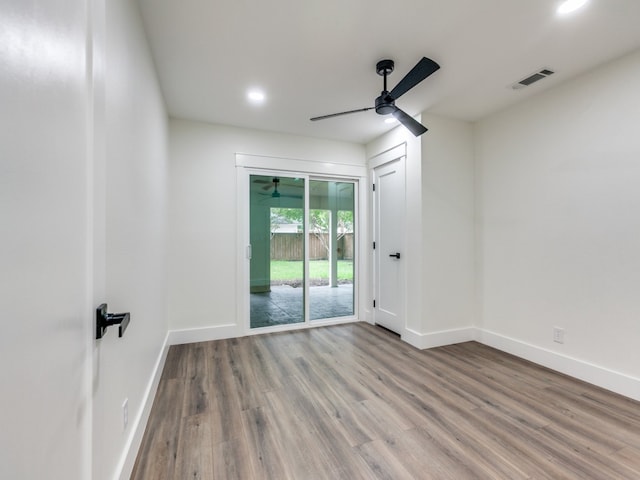 spare room featuring ceiling fan and hardwood / wood-style flooring