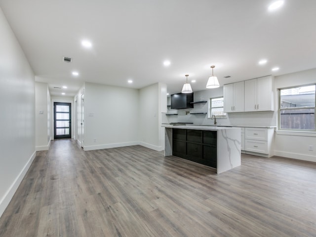 kitchen featuring a center island, plenty of natural light, and light hardwood / wood-style flooring