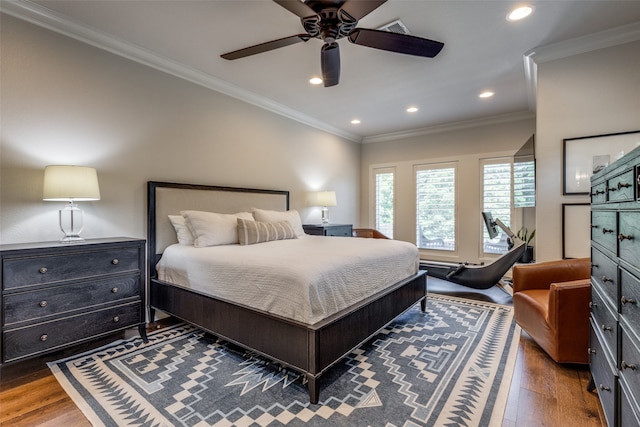 bedroom with dark wood-type flooring, ceiling fan, and ornamental molding