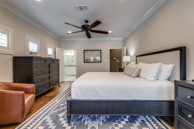 bedroom featuring hardwood / wood-style flooring, crown molding, ensuite bath, and ceiling fan