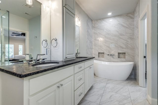 bathroom featuring vanity, ceiling fan, tile walls, a tub, and tile patterned floors