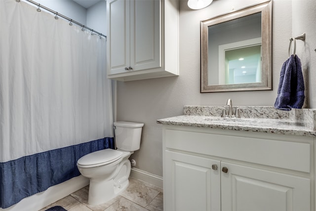 bathroom featuring vanity, toilet, and tile patterned floors