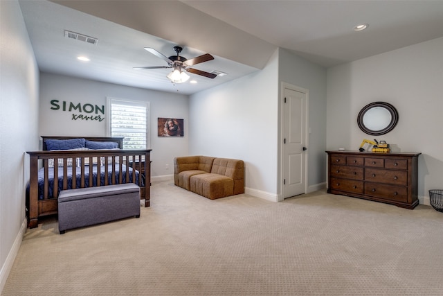 bedroom featuring light carpet and ceiling fan