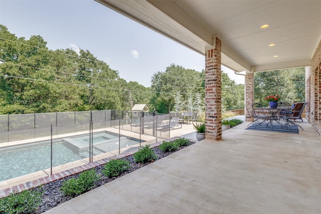 view of swimming pool with an in ground hot tub and a patio