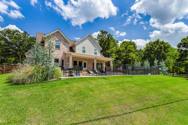 back of house featuring a patio and a lawn