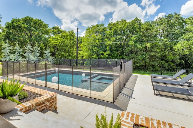 view of pool with an in ground hot tub and a patio area