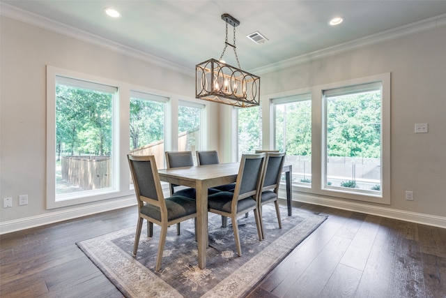 dining area featuring an inviting chandelier, a wealth of natural light, crown molding, and dark wood-type flooring