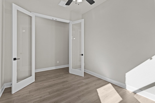 unfurnished bedroom featuring french doors, ceiling fan, and light wood-type flooring