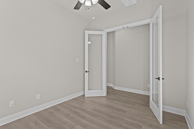 unfurnished bedroom featuring french doors, a closet, ceiling fan, and light hardwood / wood-style flooring