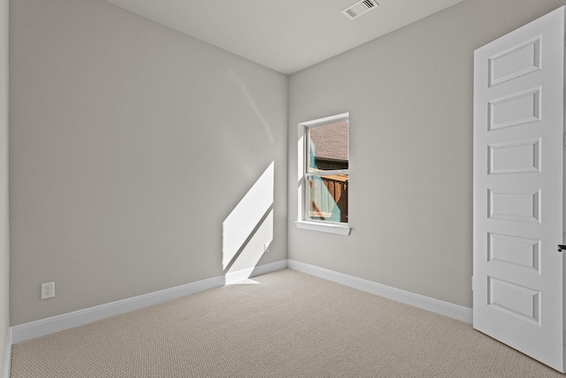 unfurnished room featuring light colored carpet